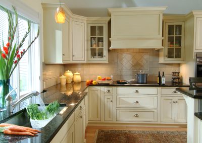 Kitchen horizontal toward stove carrots in foreground