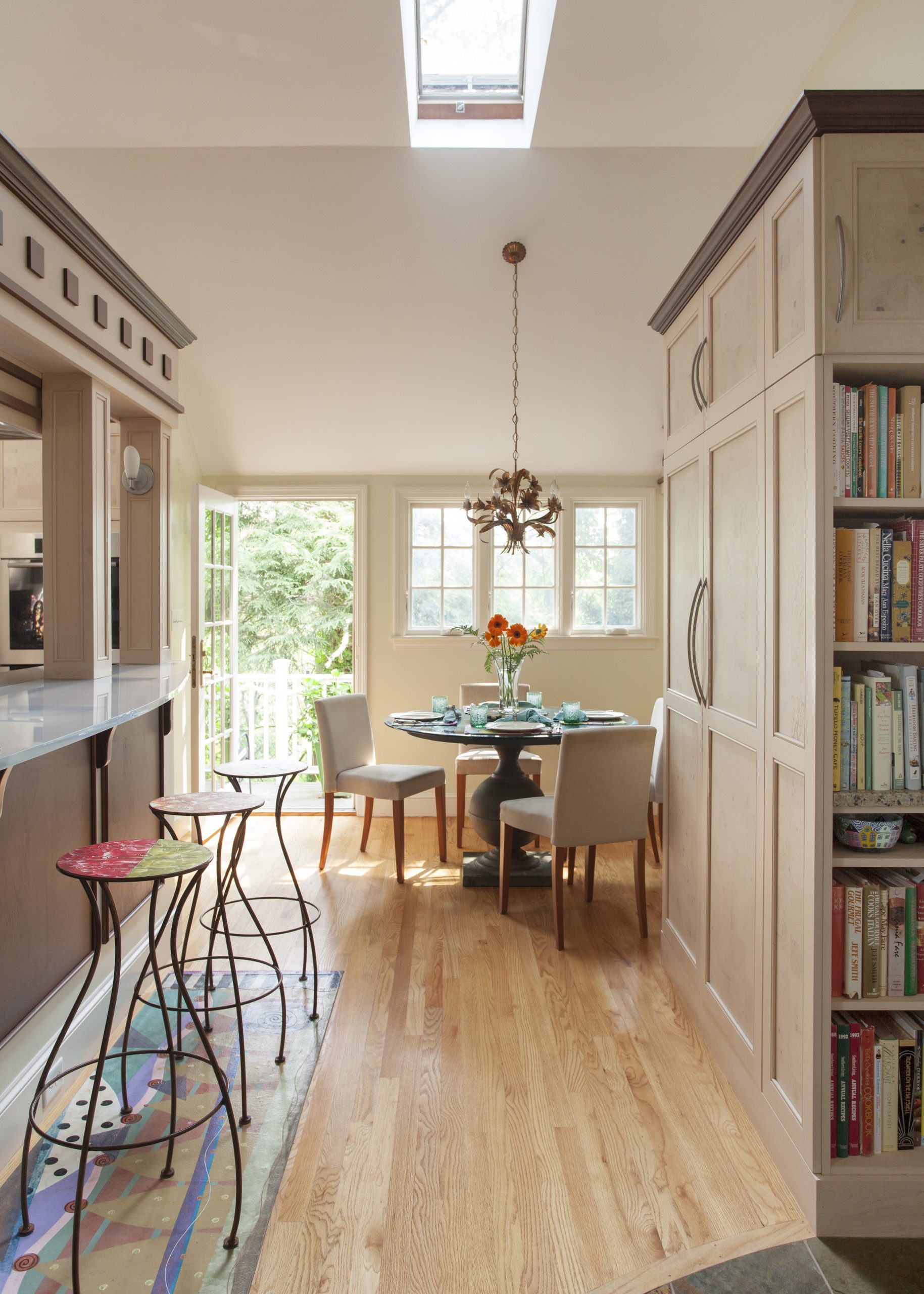 a spacious dining room with a large dining table surrounded by several chairs